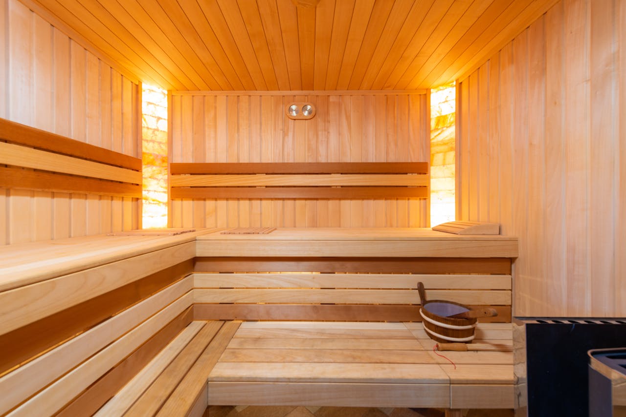 Warm indoor sauna featuring wooden benches and relaxing ambiance.